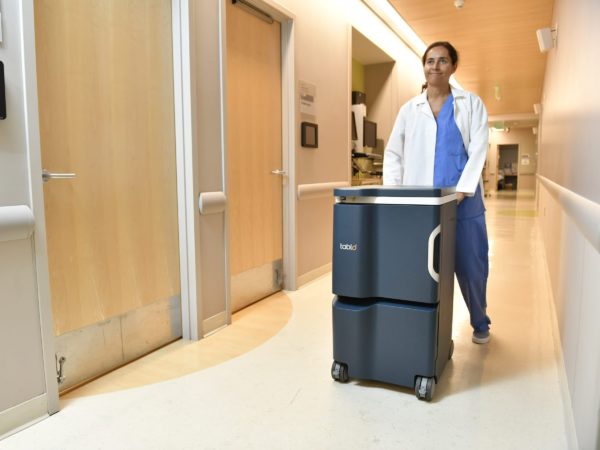 Nurse pushes Tablo down a hallway