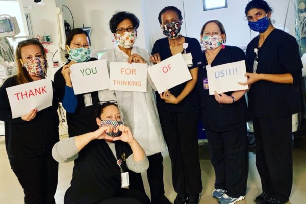 Nurses holding Tablo thank you sign