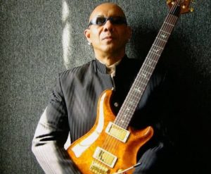 musician Reggie Boyd holding a guitar
