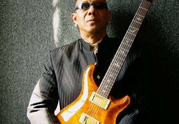 musician Reggie Boyd holding a guitar