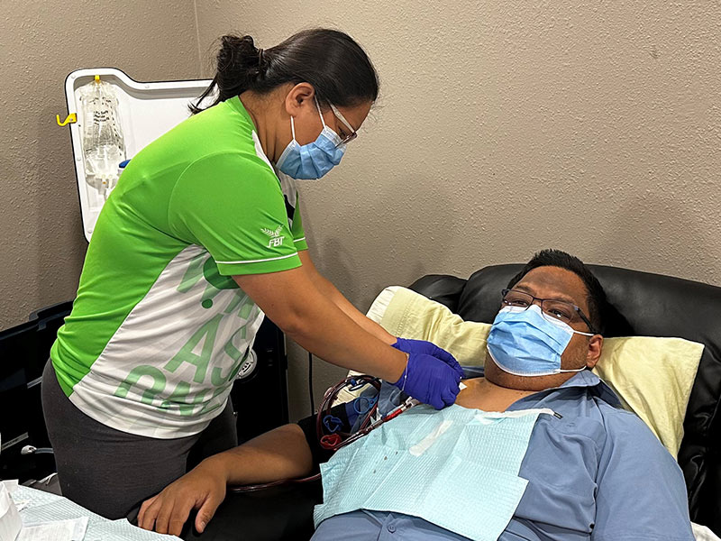 Helen preparing Andrei for a treatment at home on the Tablo Hemodialysis System.