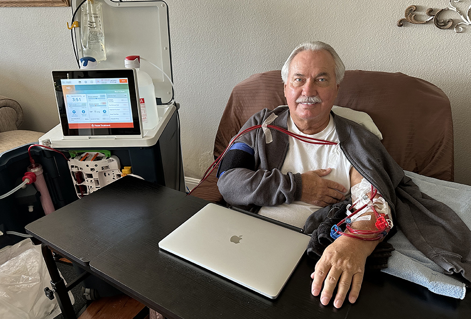 Norman at home with his Tablo during a dialysis treatment