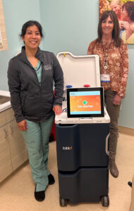 Eileen Aguilar RN, BSN, CNN (left) and Sheri Kujundzich, RN, BSN, CNN with a Tablo console at Satellite Healthcare in Orange, CA