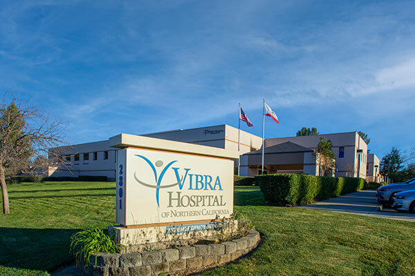 Exterior view of Vibra Hospital of Northern California and a sign, Redding, CA.