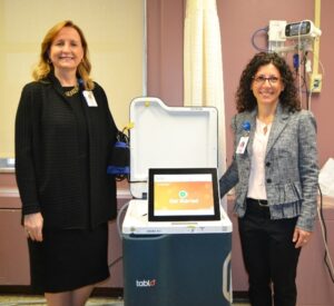 Joyce Markiewicz and Christina Tobin, with a Tablo console, at Mercy Hospital of Buffalo