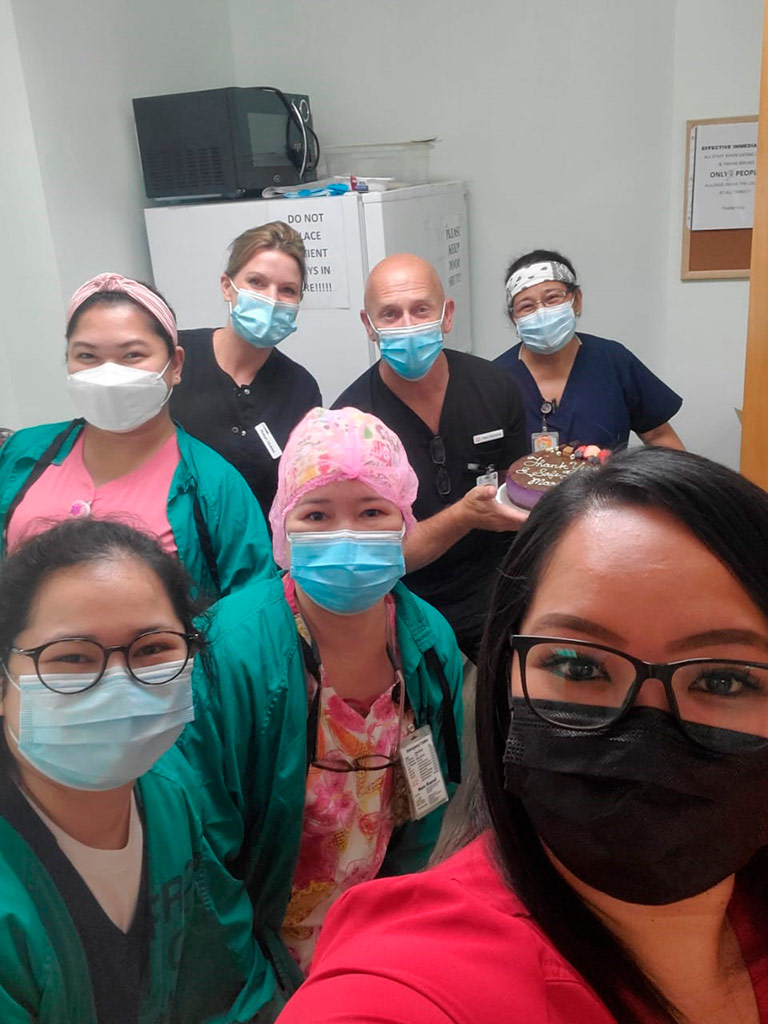 Marc Maynard, center-back, poses with nurses at Guam Memorial Hospital while on assignment