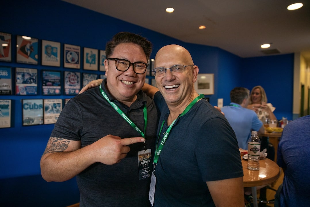 Two Outset employees smiling at a training