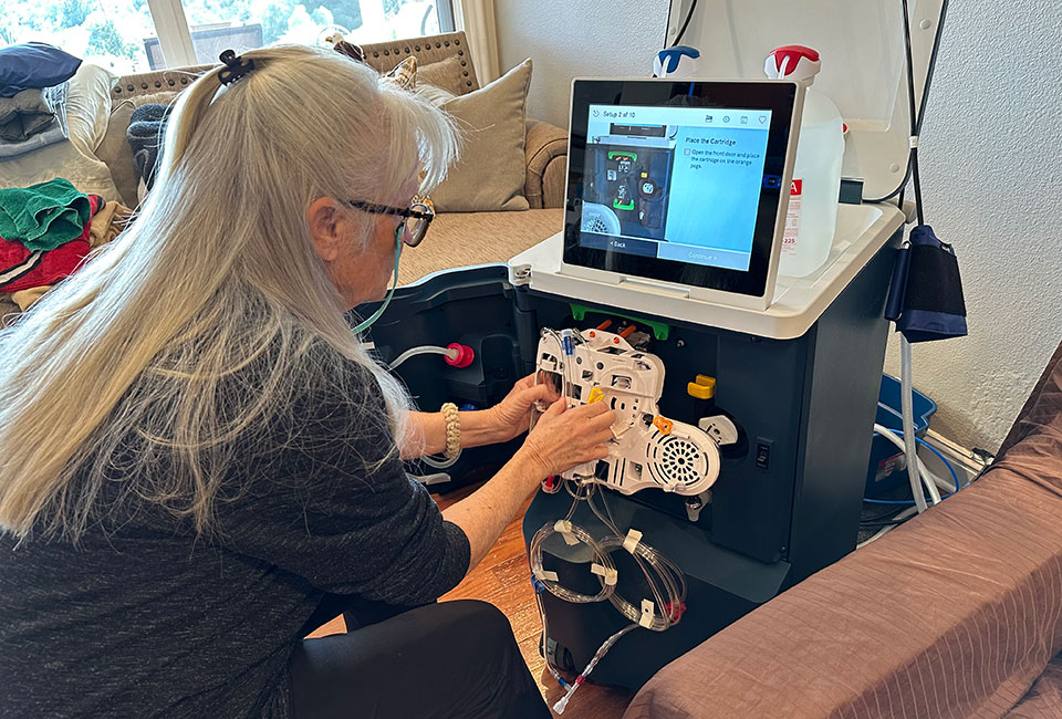 Susie installing a Tablo cartridge prior to Norman’s dialysis treatment